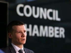 Councillor Jeromy Farkas speaks with media outside Calgary City Council chambers.