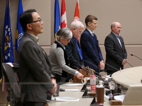 Calgary city councillors stand before a special meeting of council on Wednesday, February 19, 2020. Council met briefly before moving to an in camera meeting to discuss a possible forensic audit of Councillor Joe Magliocca's expenses.