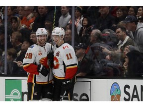 CP-Web.  Calgary Flames center Mikael Backlund, right, celebrates with center Elias Lindholm after scoring against the Anaheim Ducks during the second period of an NHL hockey game in Anaheim, Calif., Thursday, Feb. 13, 2020.