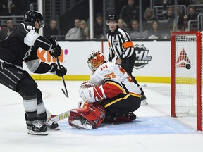 Los Angeles Kings left-winger Austin Wagner, left, scores on Calgary Flames goaltender David Rittich during the second period of an NHL hockey game Wednesday, Feb. 12, 2020, in Los Angeles.