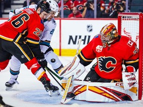 Flames goaltender David Rittich looks for the puck with San Jose Sharks forward Timo Meier bearing down during the second period at the Saddledome on Tuesday, Feb. 4, 2020.