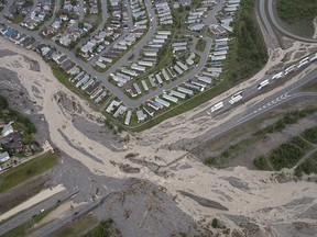 Cougar Creek runs through the Trans-Canada Highway during heavy flooding in Canmore on June 21, 2013.