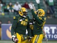 The Edmonton Eskimos' Mike Moore (96) celebrates with Jordan Hoover (28) and Kwaku Boateng (93) after recovering the ball deep in Saskatchewan Roughriders' territory during first half CFL action at Commonwealth Stadium in Edmonton Saturday Oct. 26, 2019.