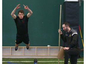 Cavalry FC's Mason Trafford (L) tests in the broad jump during fitness testing in Calgary at the Macron Performance Centre on Wednesday. Cavalry FC starts full training camp on Monday. Photo by Jim Wells/Postmedia.