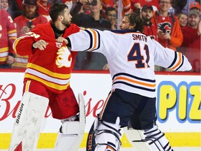 Calgary Flames goalie Cam Talbot and Edmonton Oilers counterpart Mike Smith square off at centre ice Saturday night at the Saddledome. Photo by Gavin Young/Postmedia.