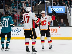 Feb 10, 2020; San Jose, California, USA; Calgary Flames center Mikael Backlund (11) celebrates with Calgary Flames left wing Milan Lucic (17) after scone a goal against the San Jose Sharks in the third period at SAP Center at San Jose. Mandatory Credit: John Hefti-USA TODAY Sports ORG XMIT: USATSI-405858