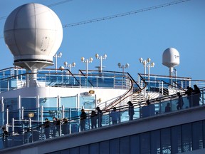 Passengers are seen on the cruise ship Diamond Princess, as the vessel's passengers continue to be tested for coronavirus, at Daikoku Pier Cruise Terminal in Yokohama, south of Tokyo, Japan February 18, 2020.