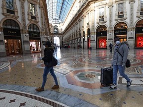 Tourists walk in Galleria Vittorio Emanuele II in the centre of Milan on Feb. 28, 2020. More than 880 people in Italy have tested positive for the coronavirus COVID-19.