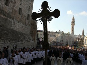 Clerigy parade in manger Square outside the Church of the Nativity in the Biblical West Bank city of Bethlehem, believed to be the birthplace of Jesus Christ, in the West Bank town of Bethlehem on December 24, 2010 as the Holy Land prepares to mark Christmas.