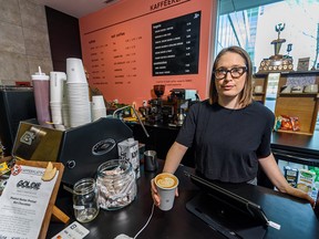 Jessica McCarrel, owner of Kaffeeklatsch coffee shop at Cambrian Wellness Centre, poses for a photo with an oat milk latte.