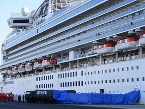 Japanese military personnel set up a covered walkway next to the Diamond Princess cruise ship, with around 3,600 people quarantined onboard due to fears of the new coronavirus, at the Daikoku Pier Cruise Terminal in Yokohama port on Feb. 10, 2020.