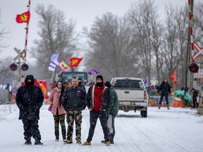 Mohawk people wait for Canada's Indigenous Services Minister Marc Miller's arrival before his meeting with representatives of the Mohawk Nation, at the site of a rail stoppage on Tyendinaga Mohawk Territory, as part of a protest against British Columbia's Coastal GasLink pipeline, in Tyendinaga, Ontario, Canada February 15, 2020.   REUTERS/Carlos Osorio ORG XMIT: GGGTYE115