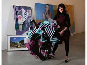 Calgary artist Tia Halliday stands with her work Fetish #2 along with some of her other art at the Herringer Kiss Gallery on Tuesday, March 3, 2020. The gallery is hosting an exhibit celebrating International Women's Day. Also featured in the picture is paintings by Shelley Addler.