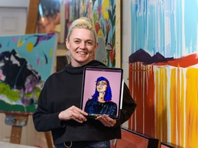 Artist Mandy Stobo with the portrait she painted of Alberta's chief medical officer of health, Dr. Deena Hinshaw, at her home studio. Azin Ghaffari/Postmedia
