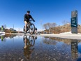 A cyclist rides his bike on Riverwalk on Friday, March 27, 2020. Calgary police are partnering with Bike Index in a bid to reduce cycle theft.