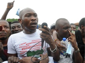 Afro music arstist and son of Fela Anikulapo Kuti, Seun Anikulapo Kuti (L) speaks for the release of schoolgirls kidnapped by Boko Haram Islamists more than two weeks ago during a workers' rally in Lagos on May 1, 2014.  The mass kidnapping in the Chibok area of northeastern Borno state was one of the most shocking attacks in Boko Haram's five-year extremist uprising, which has killed thousands across the north and centre of the country. AFP PHOTO/PIUS UTOMI EKPEIPIUS UTOMI EKPEI/AFP/Getty Images