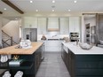 This double island features a butcher's block countertop on the left and quartz on right.