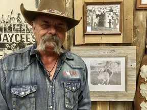 Dave Alford, curator and general manager of the Scottsdale Old Town Rodeo Museum with photos of himself from the early 1970s. Photo, Michele Jarvie