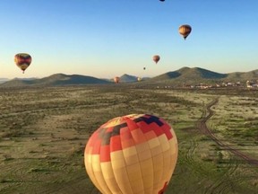 Hot air balloons soar over the desert on a sunrise trip with Hot Air Expeditions outside Scottsdale Ariz. Photo, Michele Jarvie