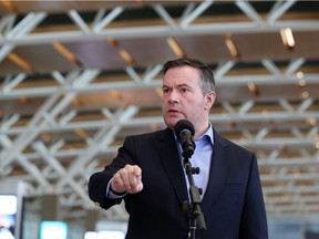Premier Jason Kenney speaks with media at the Calgary International Airport before leaving for a first ministers' conference in Ottawa on Wednesday, March 11, 2020.