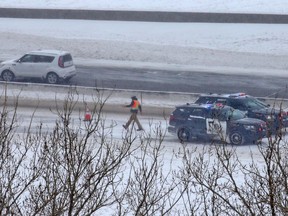 Police investigate where two Carmacks employees were struck by a car on northbound Deerfoot Trail near 17th Avenue S.E. while working outside of their vehicle.  on Saturday, March 14, 2020. EMS transported both employees in stable and non- life threatening condition. Gavin Young/Postmedia