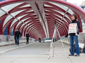 Calgary Peace Walk organizer Tina Thrussell live streams from the Peace Bridge as she encourages supporters to walk in their neighbours after this year's walk was cancelled due to COVID-19 precautions on Saturday, March 28, 2020.  Gavin Young/Postmedia