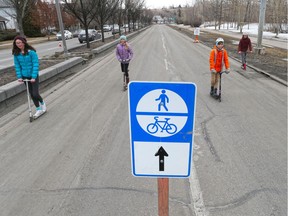Kids take advantage of the wide open lanes on the south side of Memorial Drive after the city opened them to bikes and pedestrians to help with social distancing for Calgarians as part of COVID-19 precautions on Saturday, March 28, 2020.