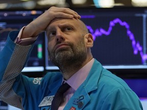 Meric Greenbaum, of Designated Market Maker IMC financial, looks up at the board before the opening bell right before trading halted on the New York Stock Exchange on March 9, 2020 in New York. This is no time to revisit Alberta's corporate tax cuts, says columnist Rob Breakenridge.