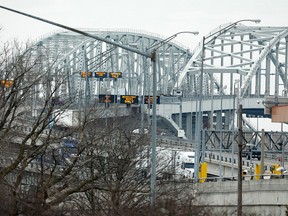 Vehicles cross the Blue Water Bridge over the St. Claire River in to Port Huron, Michigan from Sarnia, Canada, on March 18, 2020 in Port Huron, Michigan. - US and Canada have mutually agreed on March 18, 2020 to temporarily restrict " non essential traffic" accross Canada-US border due to the coronavirus pandemic. (Photo by JEFF KOWALSKY / AFP) (Photo by JEFF KOWALSKY/AFP via Getty Images)