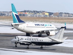 Planes ready for takeoff at the Calgary International Airport on Thursday, March 19, 2020.