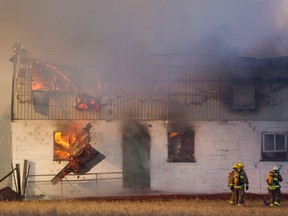 Firefighters battle a barn fire near St. Thomas, Ont. Monday, February 1, 2016. Canada's Humane Society wants Ottawa to require better fire protection systems in barns to help prevent the deaths of many thousands of animals every year.