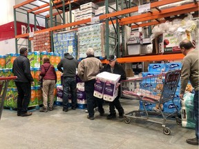 Shoppers stockpiling for COVID-19 grabbed for toilet paper as soon as a new pallet was available at the Deerfoot Heritage Costco in southwest Calgary on March 3, 2020.