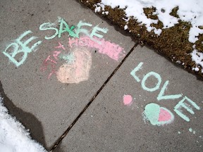A message is written in chalk on a sidewalk in Regal Terrace in Calgary on Tuesday, March 24, 2020.