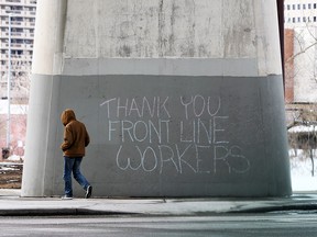 A message thanking health care workers is written in chalk on a bridge support in downtown Calgary on Tuesday, March 24, 2020.