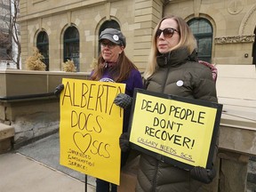 Bonnie Larson (L) and Rebecca Saah show their suppoert outside McDougall Centre in Calgary as the Government of Alberta released a report on safe consumption sites in Alberta during a press conference in Calgary on Thursday, March 5, 2020. Jim Wells/Postmeda