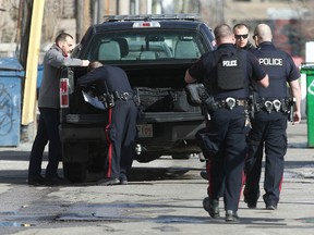 Calgary Police investigate an alleged shooting scene near 17 Ave and 7 St SW  in downtown Calgary on Sunday, March 22, 2020. A man was found hiding in a stairwell and taken into custody about four blocks away. No injuries were reported by cops may have found shell casings in an alley. Jim Wells/Postmedia