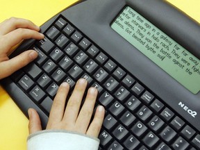 A Grade 4 student writes a story on his AlphaSmart Neos keyboard at Grovenor School in Edmonton. The keyboard assists special needs children who may have problems writing by hand.