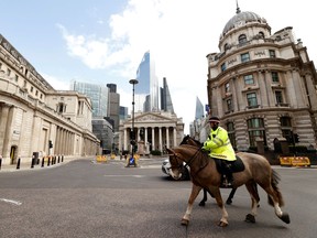 Police on horses patrol outside the Bank of England as the spread of the coronavirus disease (COVID-19) continues, London, Britain, March 31, 2020.