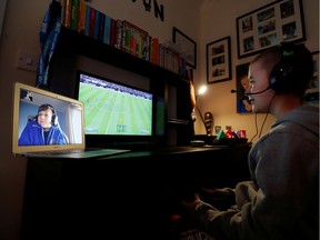 Evan Smith, 12, plays online video games with his friend Alex White, 12, while communicating through FaceTime, as the spread of coronavirus disease  continues, Ouston, Britain, March 24, 2020.