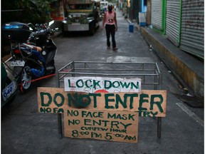 A makeshift barricade blocks a street from outsiders to protect a neighbourhood from the spread of coronavirus disease (COVID-19) in Manila, Philippines, March 23, 2020.