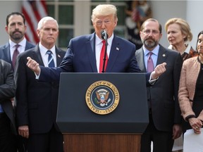 U.S. President Donald Trump stands with members of his coronavirus task force as he declares the coronavirus pandemic a national emergency during a news conference in the Rose Garden of the White House in Washington, U.S., March 13, 2020.