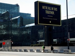 A sign displays a message outside the Jacob K. Javits Convention Center which is being partially converted into a temporary hospital in Manhattan during the outbreak of the coronavirus disease (COVID-19) in New York City, New York, U.S., March 26, 2020. REUTERS/Mike Segar ORG XMIT: PPPNYK313