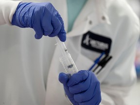FILE PHOTO: A scientist conducts research on a vaccine for the novel coronavirus (COVID-19) at the laboratories of RNA medicines company Arcturus Therapeutics in San Diego, California, U.S., March 17, 2020. REUTERS/Bing Guan/File Photo ORG XMIT: FW1