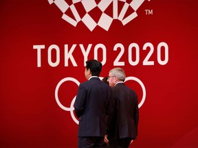 FILE PHOTO : International Olympic Committee (IOC) President Thomas Bach walks with Japan's Prime Minister Shinzo Abe during the 'One Year to Go' ceremony celebrating one year out from the start of the summer games at Tokyo International Forum in Tokyo, Japan July 24, 2019.  REUTERS/Issei Kato/File Photo ORG XMIT: TOK003