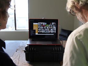 File photo: University of California, Berkeley Professors Lisa Wymore (L) and Greg Niemeyer look at the Zoom screen showing students in their online Collaborative Innovation course in Berkeley, California, U.S., March 12, 2020. REUTERS/Nathan Frandino ORG XMIT: GGG-EDU153