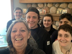 Angel's Cafe owner Cathy (front left) and her kitchen crew take a break from prepping meals for a selfie.
