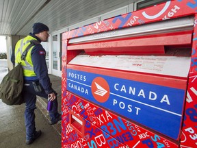 Canada Post workers return to work on November 27, 2018 in Montreal. The union representing Canada Post employees is asking Canadians to disinfect their mail boxes to help prevent the spread of COVID-19. And the post office itself is asking Canadians with dogs to keep their doors closed during deliveries, where possible. The Canadian Union of Postal Workers says daily washing and disinfecting of letter boxes, along with handrails and door knobs, will help keep mail carriers safe.