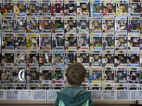 Three-year-old Jaxon Ambrose looks at wall of Funko Pops at "Pop Swap", an event for collectors of the vinyl figurines to buy, sell and trade held at the Lambeth Legion in London, Ont. on Sunday March 3, 2019. Funko Pops are modeled after all manner of pop culture icons from comic book characters to rock and roll stars. More than 6,000 different styles have been released since they were introduced in 2012.  Jaxon's favourite is Spider-Man. Derek Ruttan/The London Free Press/Postmedia Network ORG XMIT: POS1903031610422897