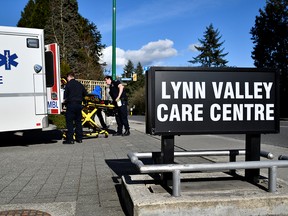 A paramedic removes protective gear outside the Lynn Valley Care Centre in North Vancouver, on March 9, 2020.