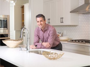 Raphael Jimenez of Homes by Us in the kitchen of the Sonoma show home in Walden. The walk-through pantry entrance is in the corner of the kitchen.